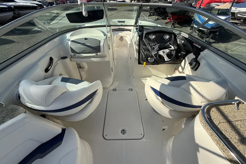 Slide: The Image of 2011 Monterey 264 FS boat interior with white seating and steering console. - 7