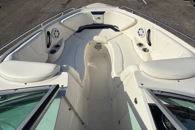 Slide: The Image of 2011 Monterey 264 FS boat interior with white seating and cup holders. - 8
