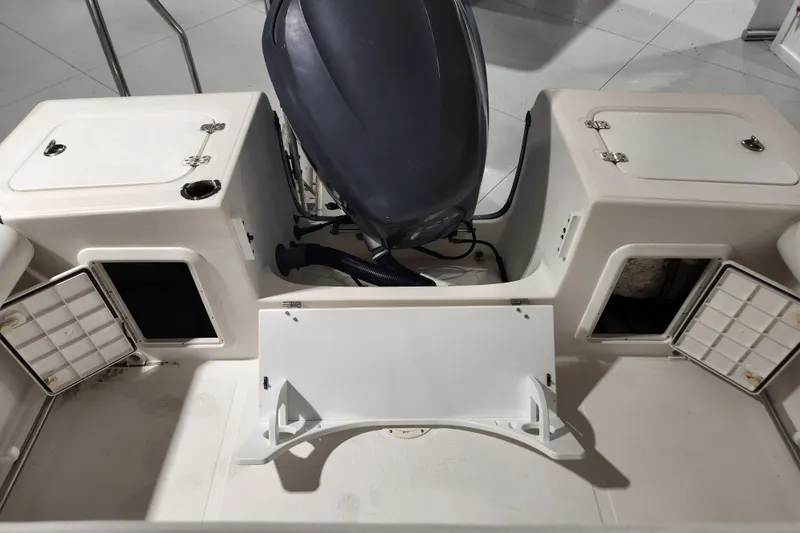 Slide: The Image of 2004 Edgewater 225CC boat interior with storage compartments and seating area. - 10