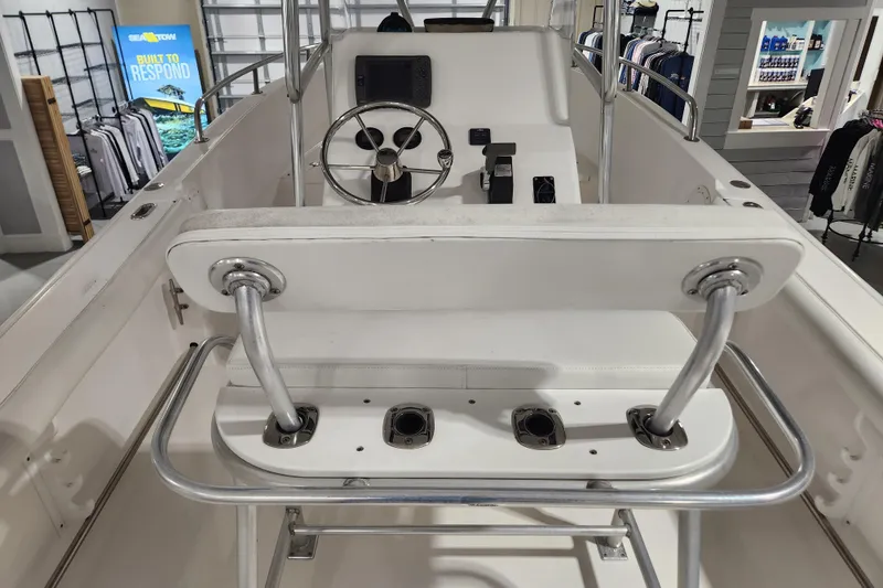 Slide: The Image of 2004 Edgewater 225CC boat interior with steering wheel and controls in showroom. - 12