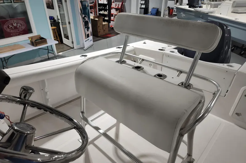 Slide: The Image of 2004 Edgewater 225CC boat interior with steering wheel and seating in showroom. - 15