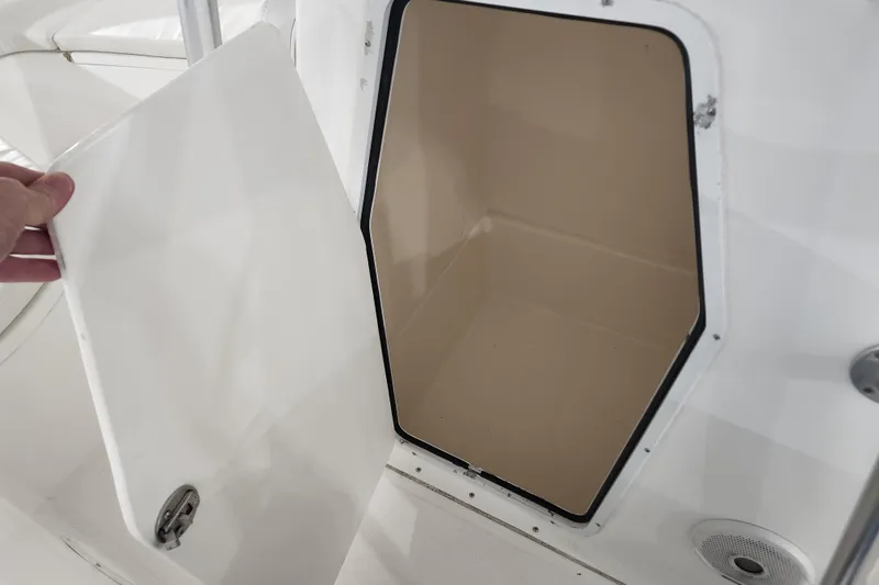 Slide: The Image of Open storage compartment on a 2004 Edgewater 225CC boat. - 16