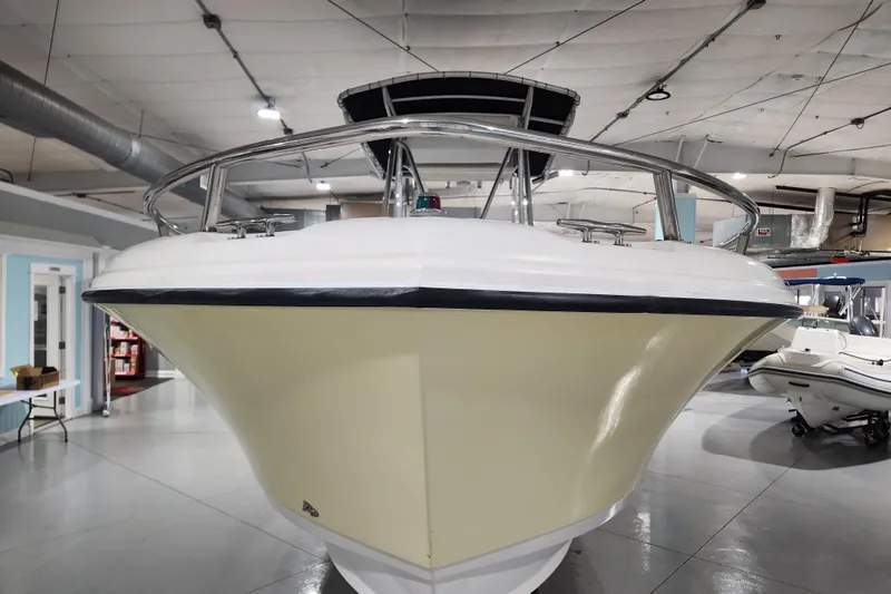 Slide: The Image of 2004 Edgewater 225CC boat displayed indoors, showcasing its sleek hull design. - 2