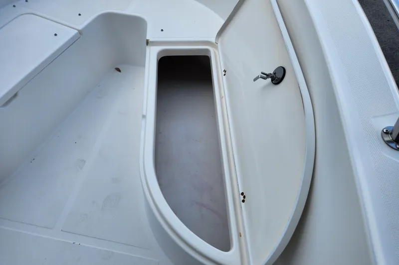 Slide: The Image of Open storage compartment on a 2004 Edgewater 225CC boat, showcasing interior space. - 20