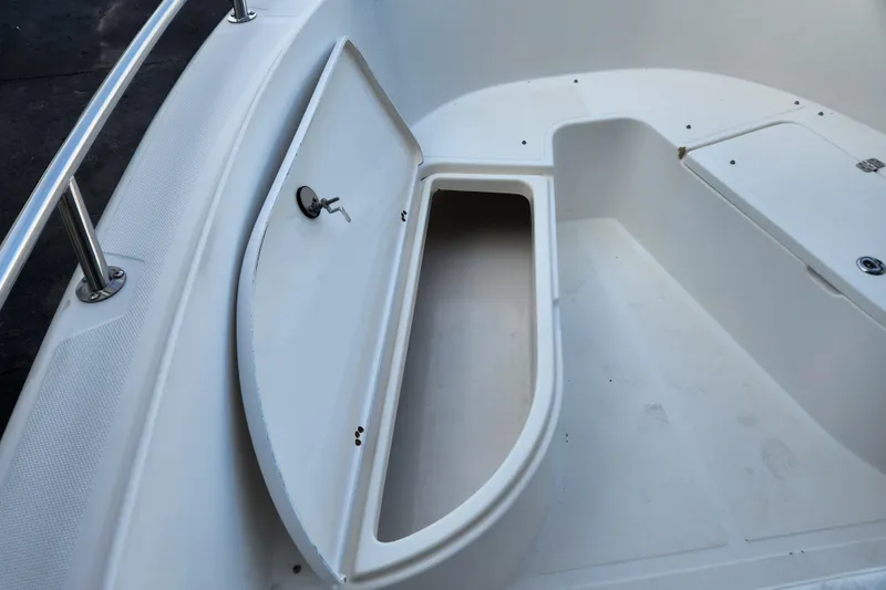 Slide: The Image of Open storage compartment on 2004 Edgewater 225CC boat deck. - 21