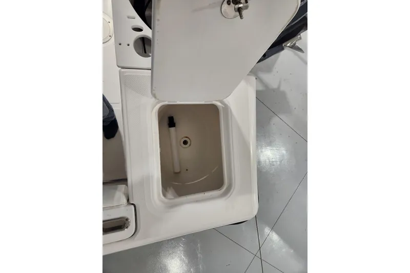 Slide: The Image of Open storage compartment on 2004 Edgewater 225CC boat, featuring a white interior. - 22