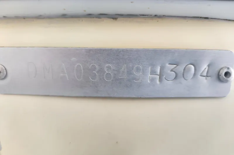 Slide: The Image of 2004 Edgewater 225CC boat identification plate with serial number DMA03849H304. - 27