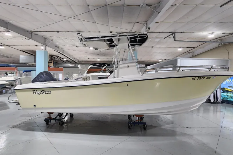 Slide: The Image of 2004 Edgewater 225CC boat displayed in indoor showroom. - 3