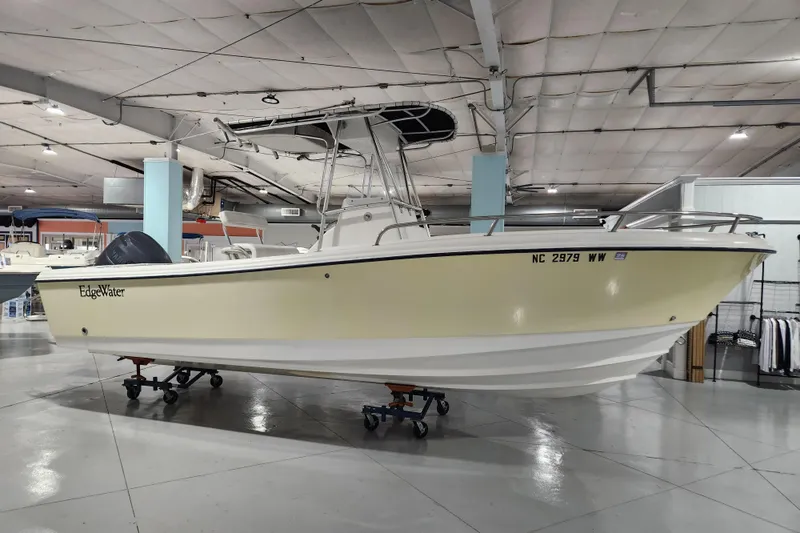 Slide: The Image of 2004 Edgewater 225CC boat displayed indoors on a trailer. - 4