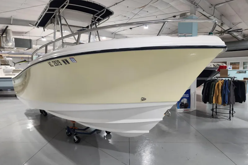Slide: The Image of 2004 Edgewater 225CC boat displayed indoors, showcasing sleek design and sturdy build. - 5