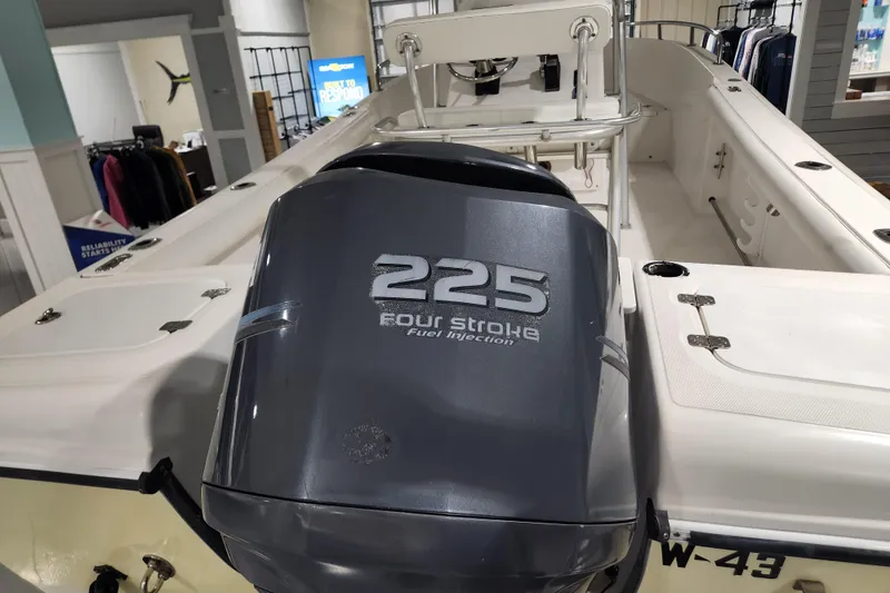 Slide: The Image of 2004 Edgewater 225CC boat with 225 four-stroke engine, displayed indoors. - 6