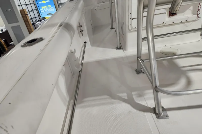 Slide: The Image of 2004 Edgewater 225CC boat interior with stainless steel railings and white deck. - 8