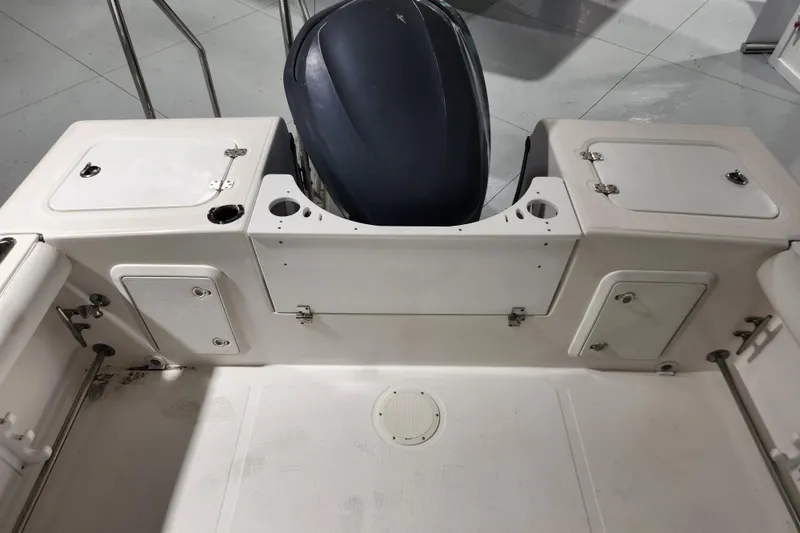 Slide: The Image of 2004 Edgewater 225CC boat interior with storage compartments and motor cover. - 9