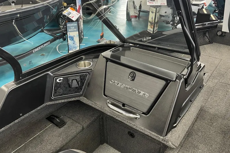 Slide: The Image of 2026 Crestliner 1750 Fish Hawk WT JS boat interior with storage compartment and cup holder. - 11