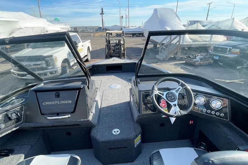 Slide: The Image of 2026 Crestliner 1750 Fish Hawk WT JS boat interior with seating and motor. - 5