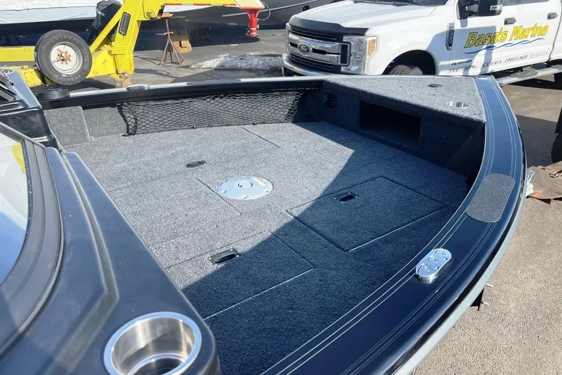 Slide: The Image of 2026 Crestliner 1750 Fish Hawk WT JS boat interior with carpeted deck and storage compartments. - 8