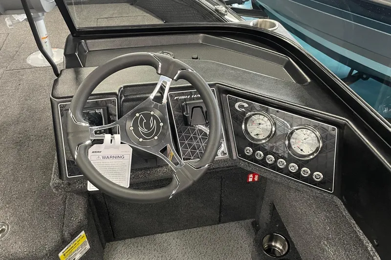 Slide: The Image of 2026 Crestliner 1750 Fish Hawk WT JS dashboard with steering wheel and gauges. - 9
