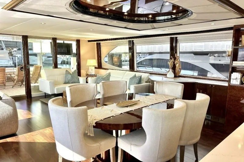 Slide: The Image of Luxurious interior of 2001 Lazzara 94 Motor Yacht with elegant dining area and plush seating. - 11