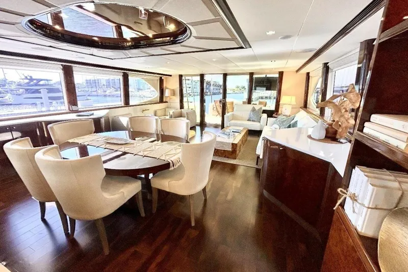 Slide: The Image of Luxurious interior of 2001 Lazzara 94 Motor Yacht with elegant dining and seating area. - 12