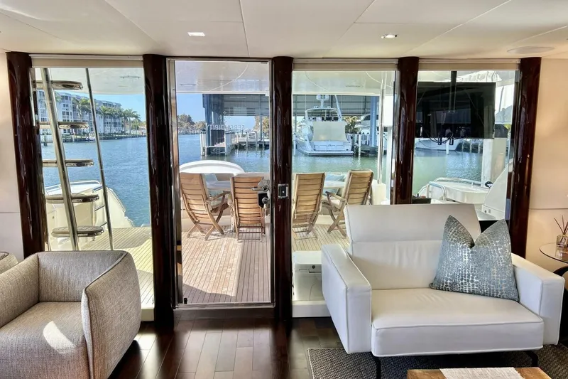 Slide: The Image of Luxurious interior of 2001 Lazzara 94 Motor Yacht with waterfront view and elegant seating. - 17