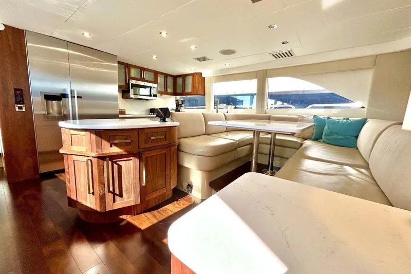 Slide: The Image of Luxurious interior of 2001 Lazzara 94 Motor Yacht with modern kitchen and seating area. - 19