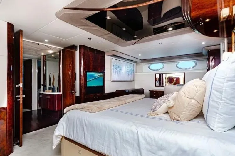 Slide: The Image of Luxurious bedroom interior of 2001 Lazzara 94 Motor Yacht with elegant wood finishes. - 26