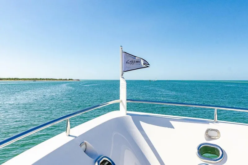 Slide: The Image of 2001 Lazzara 94 Motor Yacht cruising on clear blue waters under a sunny sky. - 42