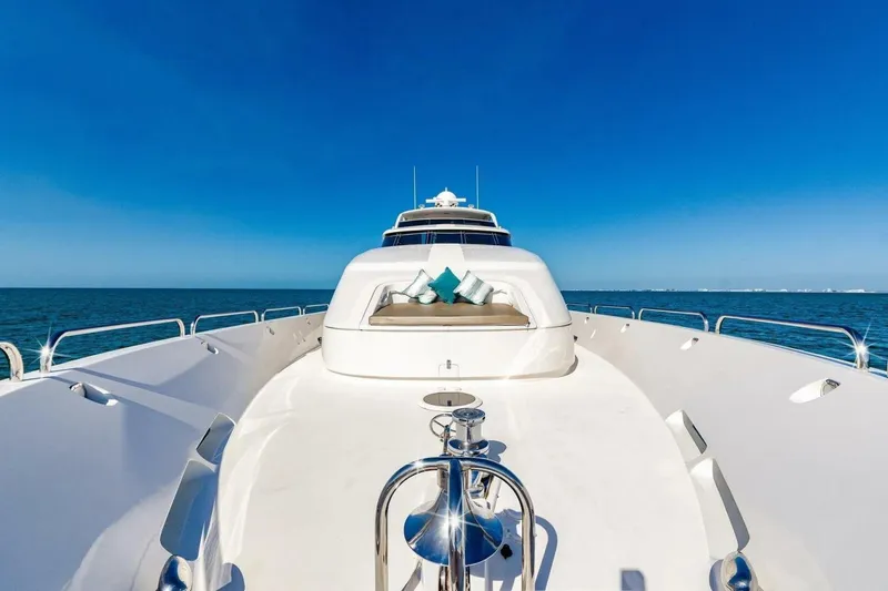 Slide: The Image of 2001 Lazzara 94 Motor Yacht on open sea, clear blue sky, luxurious deck view. - 43