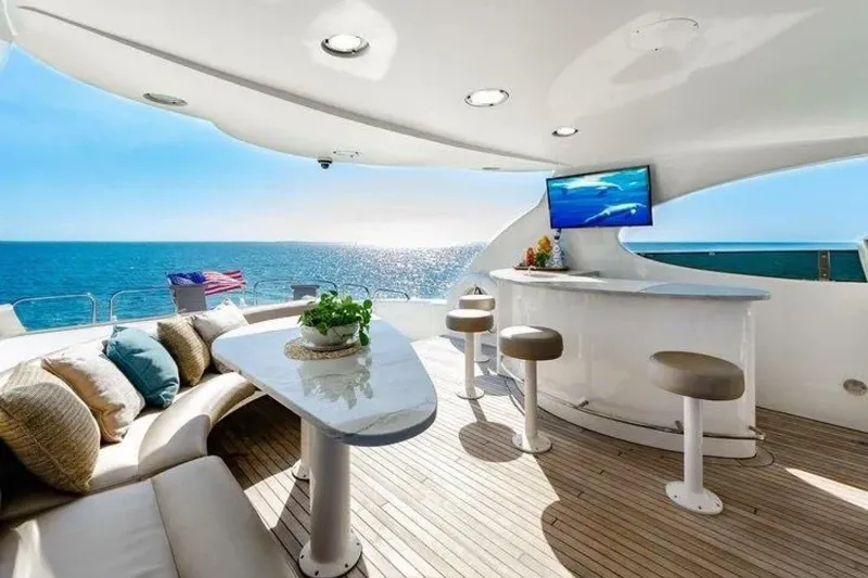 Slide: The Image of Luxurious 2001 Lazzara 94 Motor Yacht deck with seating, bar, and ocean view. - 47