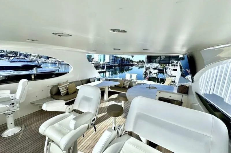 Slide: The Image of Luxurious 2001 Lazzara 94 Motor Yacht interior with elegant seating and marina view. - 50