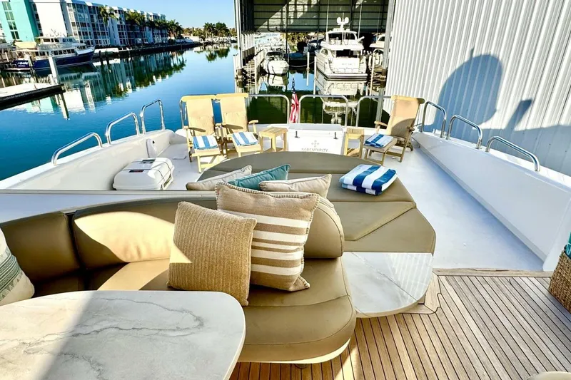 Slide: The Image of Luxurious 2001 Lazzara 94 Motor Yacht deck with elegant seating and marina view. - 52