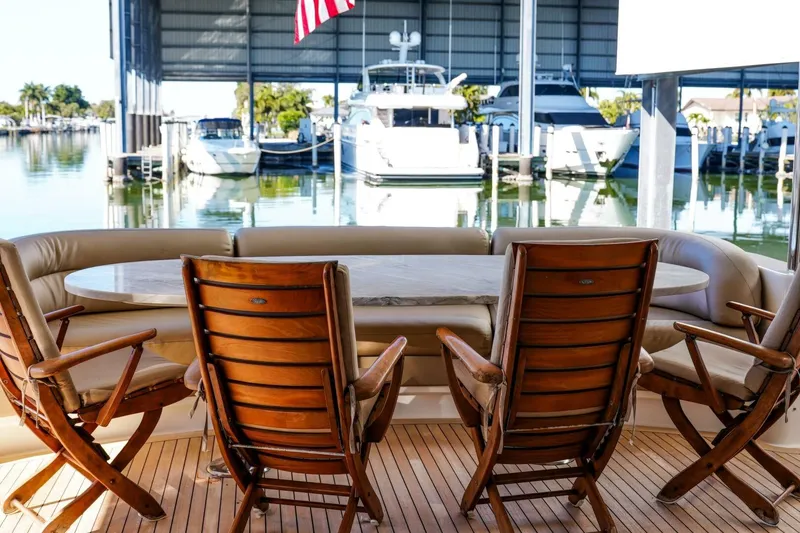 Slide: The Image of Luxury Lazzara 94 Motor Yacht 2001, elegant outdoor seating with marina view. - 56