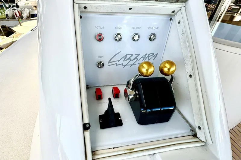 Slide: The Image of Control panel of a 2001 Lazzara 94 Motor Yacht with throttle levers and switches. - 57