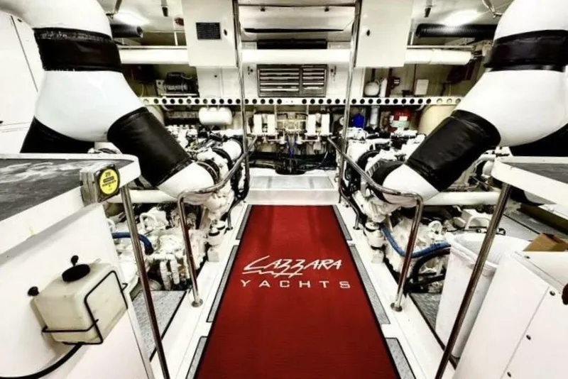 Slide: The Image of Engine room of 2001 Lazzara 94 Motor Yacht with red carpet and machinery. - 58