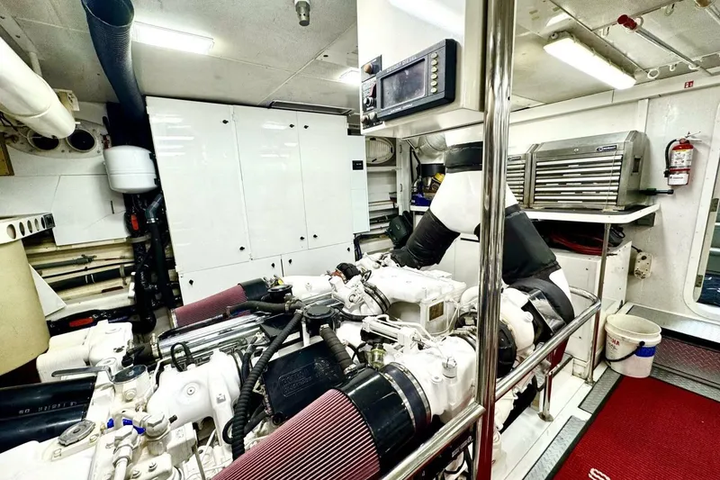 Slide: The Image of Engine room of 2001 Lazzara 94 Motor Yacht, featuring machinery and storage cabinets. - 59
