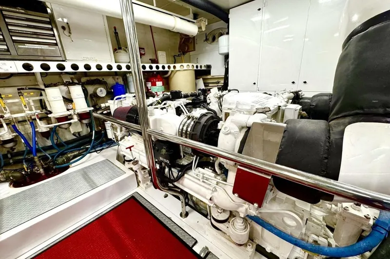 Slide: The Image of Engine room of 2001 Lazzara 94 Motor Yacht, featuring complex machinery and piping. - 60