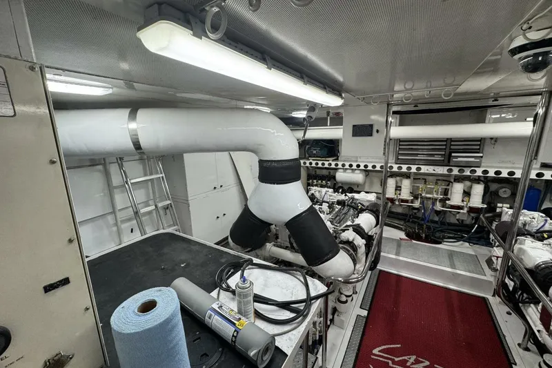 Slide: The Image of Engine room of a 2001 Lazzara 94 Motor Yacht, featuring machinery and maintenance tools. - 62