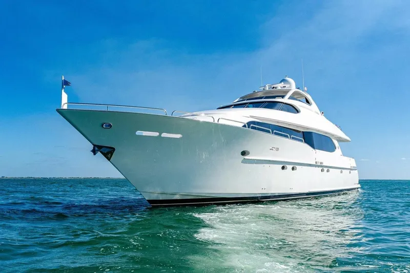 Slide: The Image of Luxury 2001 Lazzara 94 Motor Yacht cruising on open water under clear blue sky. - 67