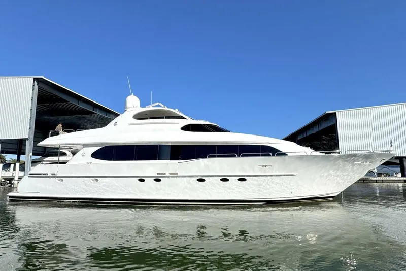 Slide: The Image of 2001 Lazzara 94 Motor Yacht docked in marina under clear blue sky. - 75