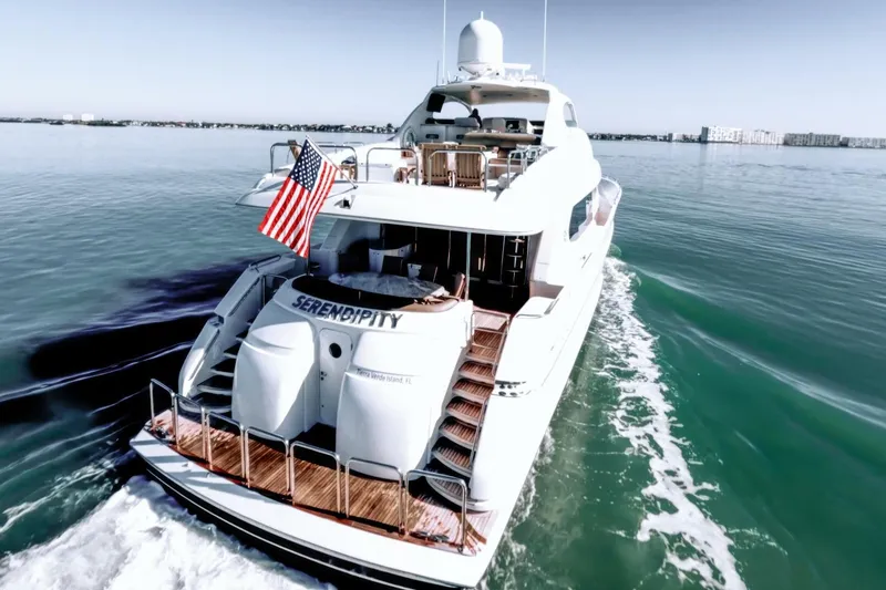 Slide: The Image of 2001 Lazzara 94 Motor Yacht cruising with American flag on calm waters. - 77