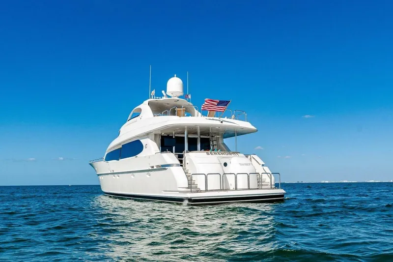 Slide: The Image of 2001 Lazzara 94 Motor Yacht on open water under clear blue sky. - 78