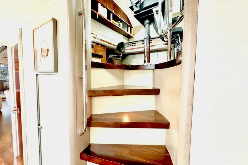 Slide: The Image of Staircase inside 2001 Lazzara 94 Motor Yacht with wooden steps and metal railing. - 9