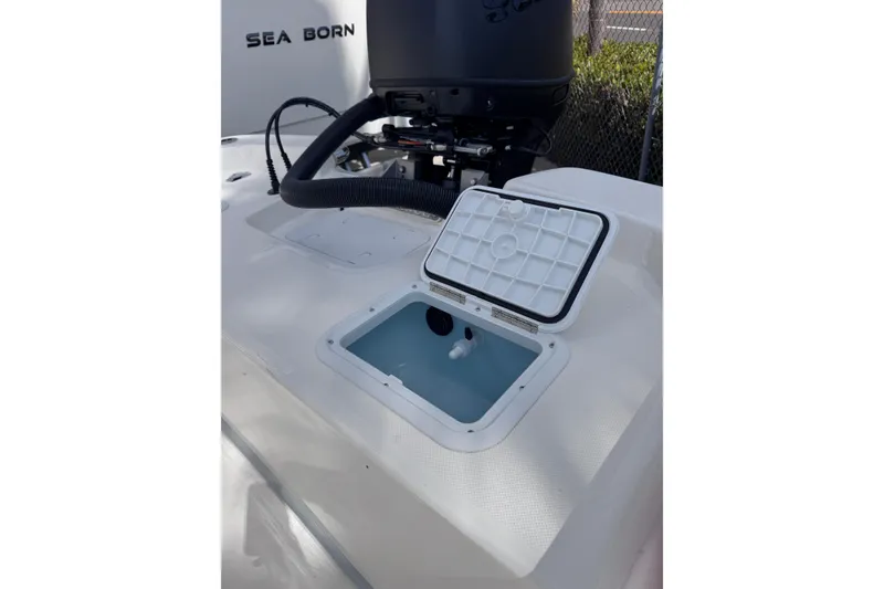 Slide: The Image of 2026 Sundance B20CCR boat with open storage compartment and visible engine. - 7