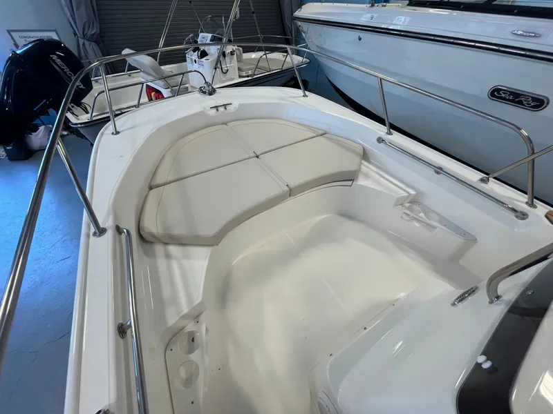 Slide: The Image of The image shows the cockpit of a Boston Whaler 170 Montauk with white cushions and stainless steel railings. - 11