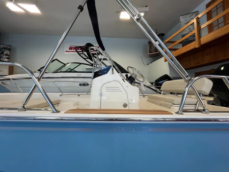 Slide: The Image of Interior view of a Boston Whaler 170 Montauk with helm console and seating area. - 17