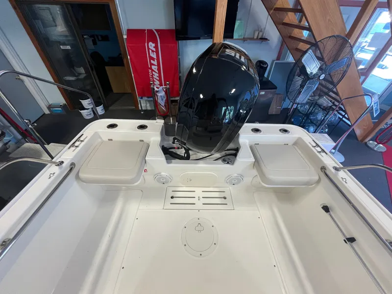 Slide: The Image of Interior view of a Boston Whaler 170 Montauk with a black outboard motor. - 3