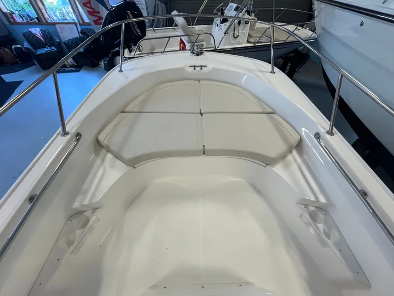 Slide: The Image of The image shows the bow of a Boston Whaler 170 Montauk boat with white cushions. - 13