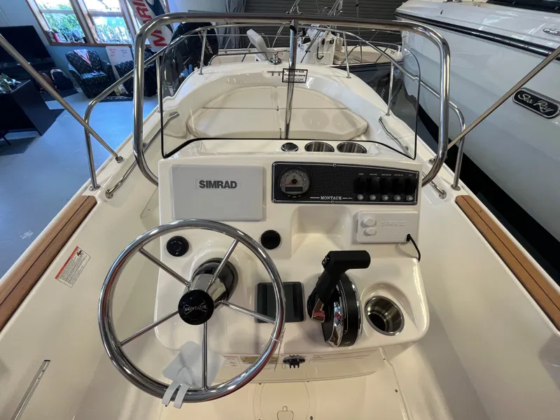 Slide: The Image of The image shows the cockpit of a Boston Whaler 170 Montauk with a Simrad control system. - 10