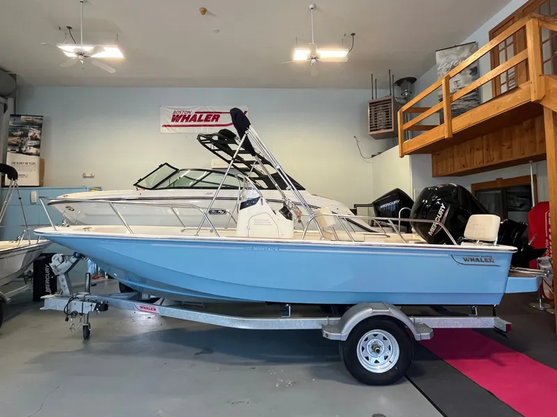 Slide: The Image of A 2026 Boston Whaler 170 Montauk on a trailer in a showroom. - 0
