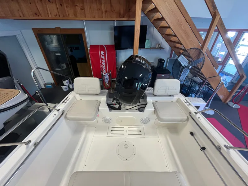 Slide: The Image of Interior view of a Boston Whaler 170 Montauk with an outboard motor and seating. - 2